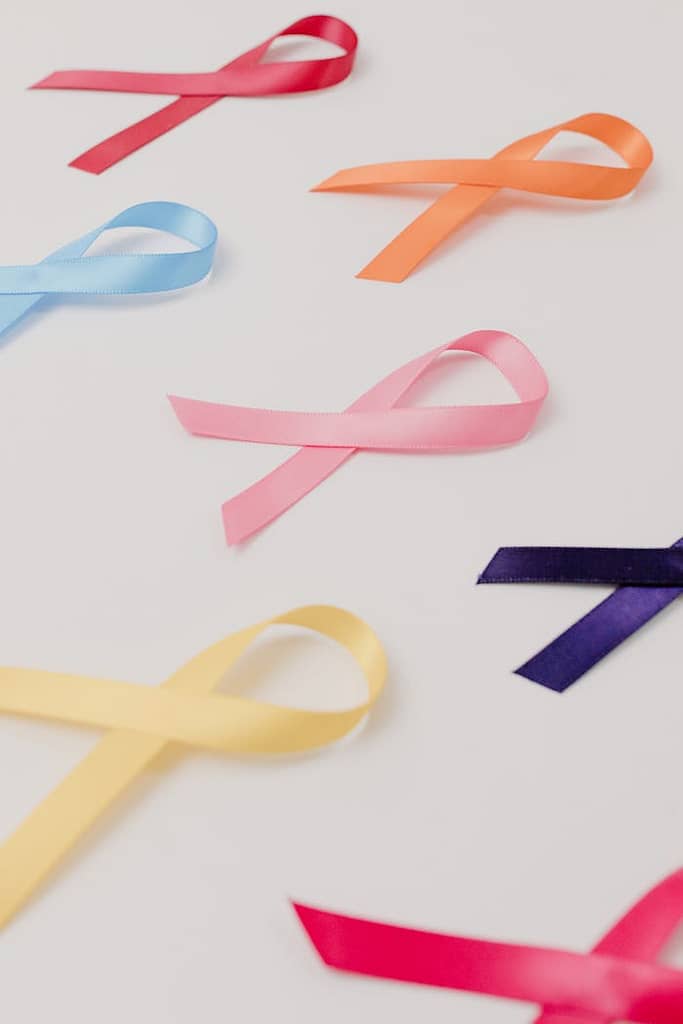 a-close-up-shot-of-ribbons-in-different-colors-7723535 Vibrant awareness ribbons representing various causes on a white surface.